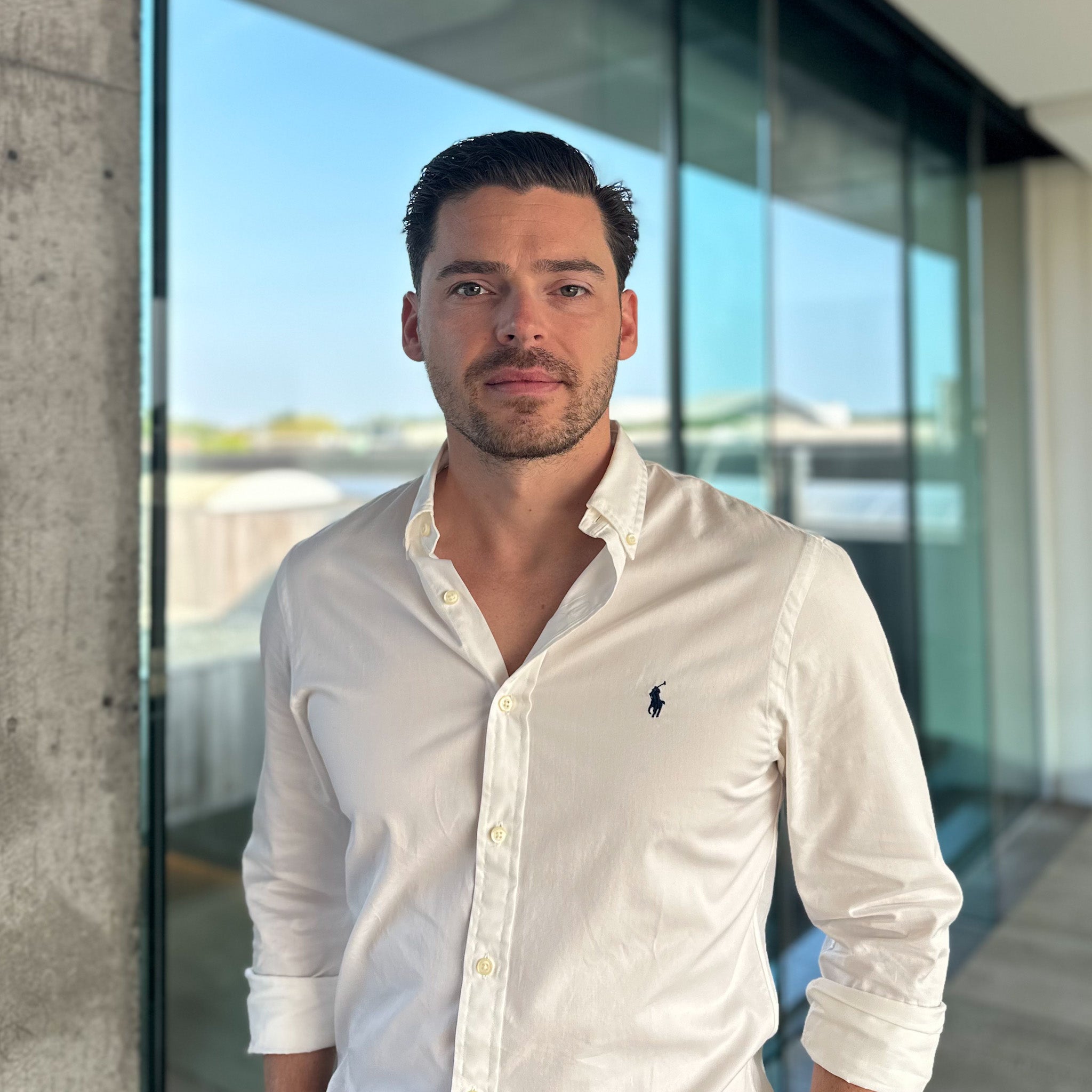 Jeremy De Meyer, a man with dark hair and a beard, in a white button-down shirt.